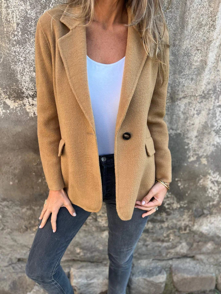 Classic lapel suit jacket worn by a woman, showcasing timeless fashion with a chocolate brown design and casual styling.